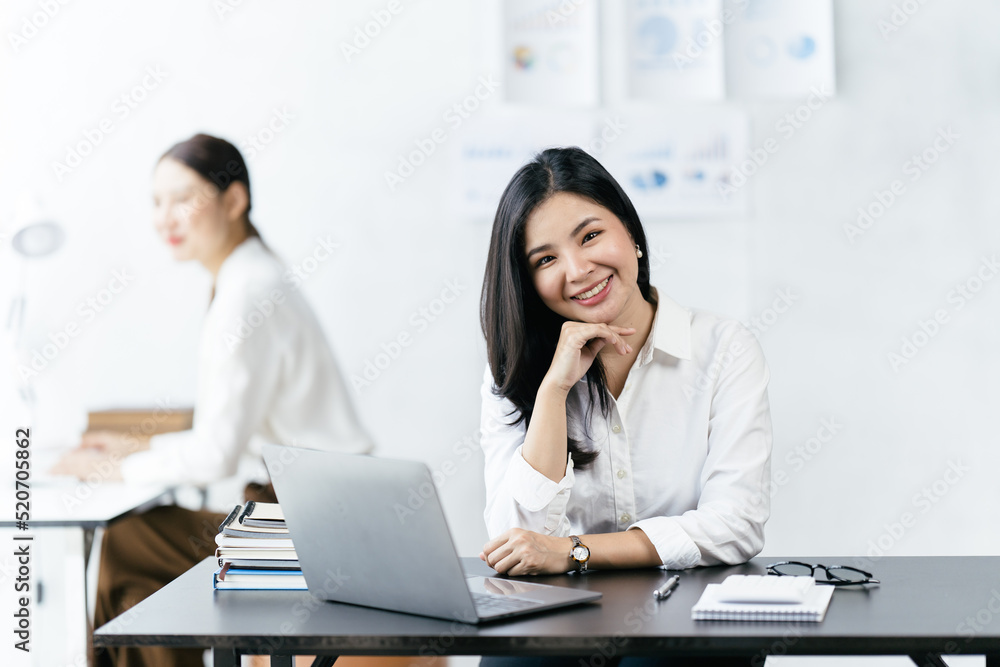 Asian woman working with laptop in her office. business financial concept. Asian woman working with laptop in her office. business financial concept.