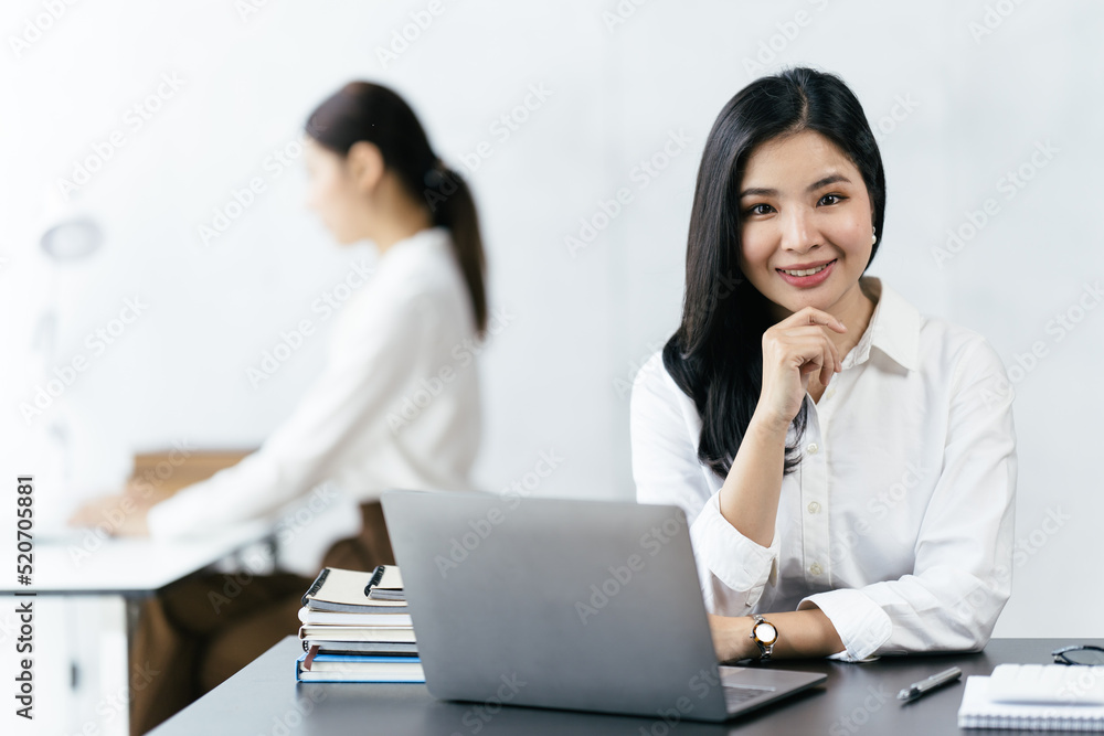 Asian woman working with laptop in her office. business financial concept. Asian woman working with laptop in her office. business financial concept.
