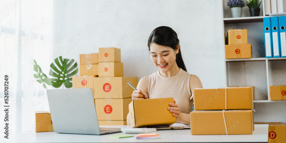 Young start up business woman Asian people working as SME entrepreneur new business with packaging box, preparing for send to client. Young start up business woman Asian people working as SME entrepreneur new business with packaging box, preparing for send to client.