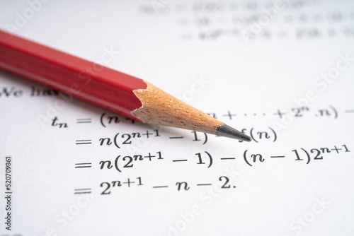 Pencil on mathematic formula exercise test paper in education school.