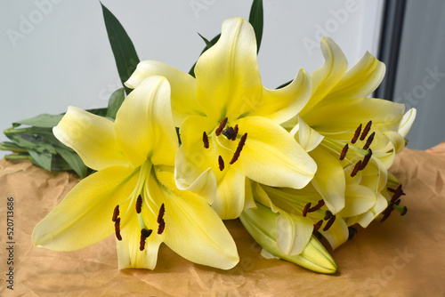 Fototapeta Naklejka Na Ścianę i Meble -  Yellow Lilly bouquet on craft paper