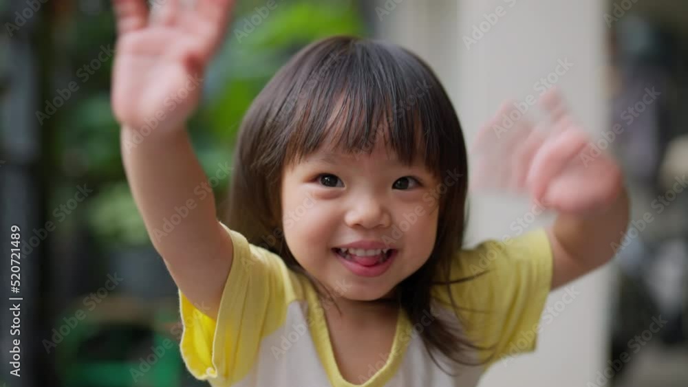 smiling happiness asian baby child girl sit relax at home say hi hand waving greeting to camera with cheerful laugh smile fun with energy of youth,cute girl smiling to camera smiling happiness asian baby child girl sit relax at home say hi hand waving greeting to camera with cheerful laugh smile fun with energy of youth,cute girl smiling to camera