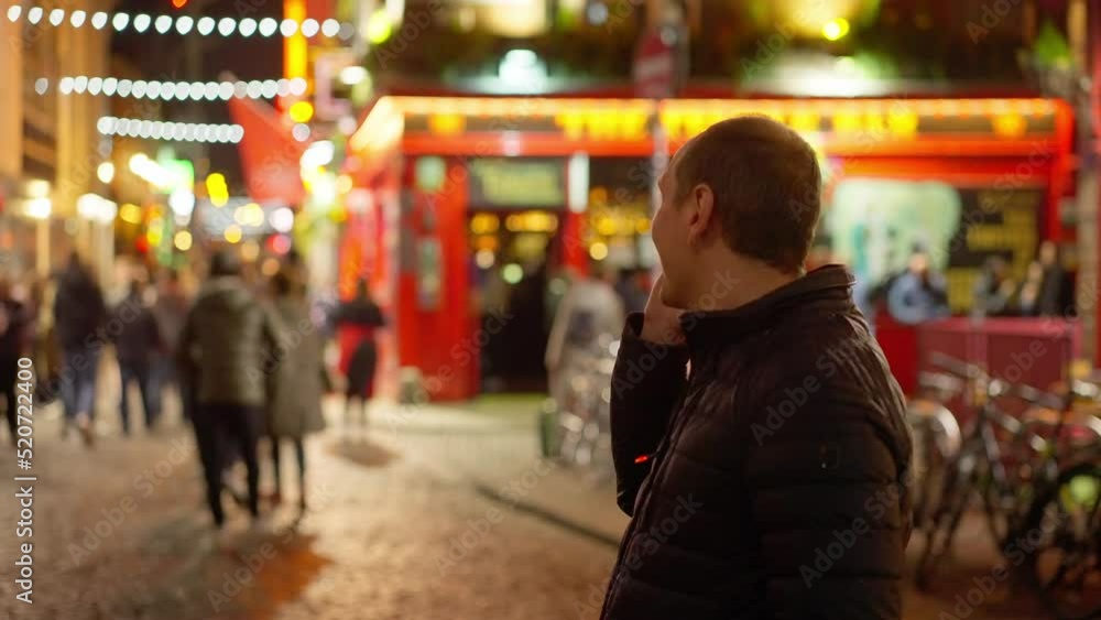 Guys drinking a beer in the Temple Bar district of Dublin by night - Ireland travel photography Guys drinking a beer in the Temple Bar district of Dublin by night - Ireland travel photography