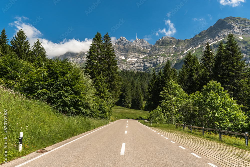 Mountain road with view of the Alpstein massif and Mount Säntis. Switzerland