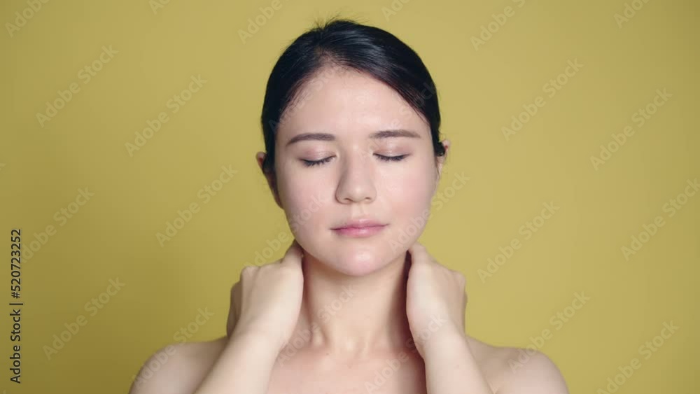 Young Latina woman massaging her neck. Young Latina woman massaging her neck.