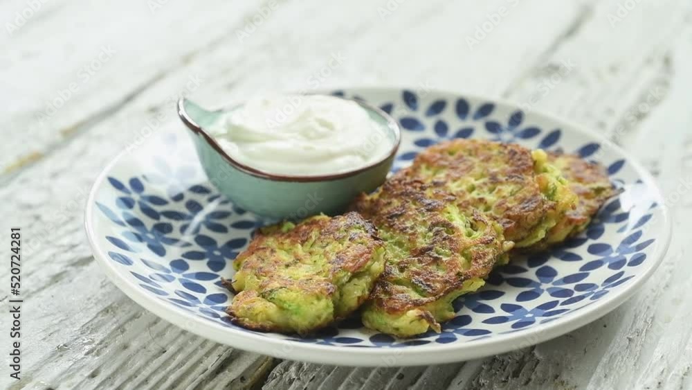 The chef serves zucchini and halloumi fritters.
The chef serves zucchini and halloumi fritters.