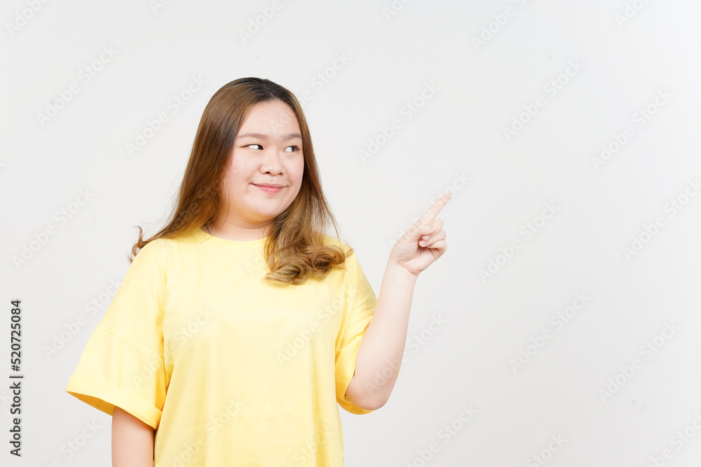 Showing Product and Pointing Side of Beautiful Asian Woman wearing yellow T-Shirt Isolated On White Showing Product and Pointing Side of Beautiful Asian Woman wearing yellow T-Shirt Isolated On White