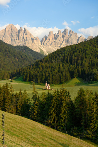 Stunning view of the Church of St. John (San Giovanni in Ranui ) that stands out in the green meadows, in the heart of the beautiful Dolomitic mountain landscape.