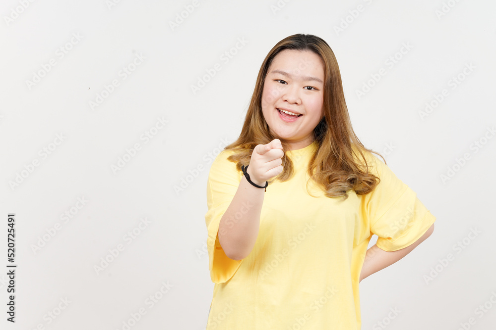 Smiling and pointing at you of Beautiful Asian Woman wearing yellow T-Shirt Isolated On White Smiling and pointing at you of Beautiful Asian Woman wearing yellow T-Shirt Isolated On White