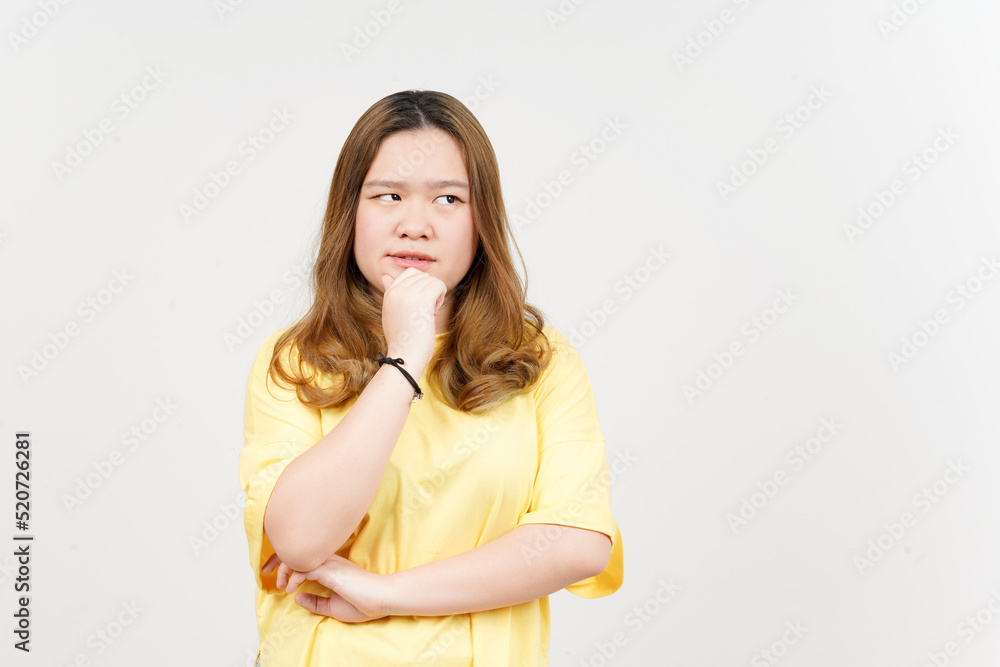 Thinking gesture of Beautiful Asian Woman wearing yellow T-Shirt Isolated On White Background Thinking gesture of Beautiful Asian Woman wearing yellow T-Shirt Isolated On White Background