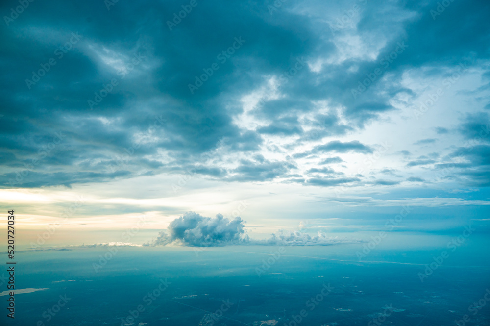 Aerial view of clouds from the sky. Clouds, a view from airplane window. Beautiful sunrise cloudy sky from aerial view