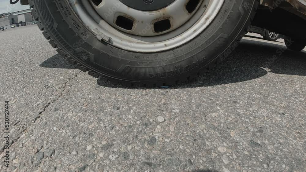 Slo mo, heavy vehicle drives over smartphone on street pavement Slo mo, heavy vehicle drives over smartphone on street pavement