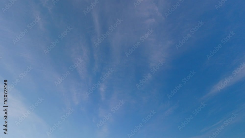 Time lapse of high wispy clouds moving across empty deep blue sky Time lapse of high wispy clouds moving across empty deep blue sky