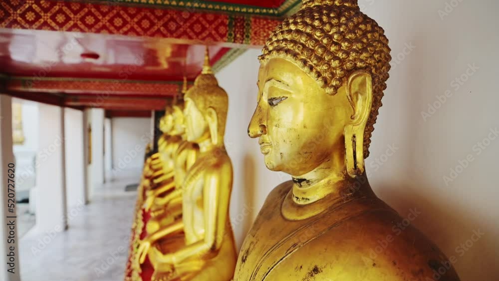 Stockvideo Close Up Gold Leaf Buddha Statues in Bangkok, Thailand at