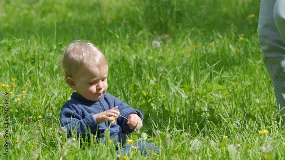 Mother and child walk in the park in summer, happy kid playing with mom on green grass on a sunny day. Mother and child walk in the park in summer, happy kid playing with mom on green grass on a sunny day.
