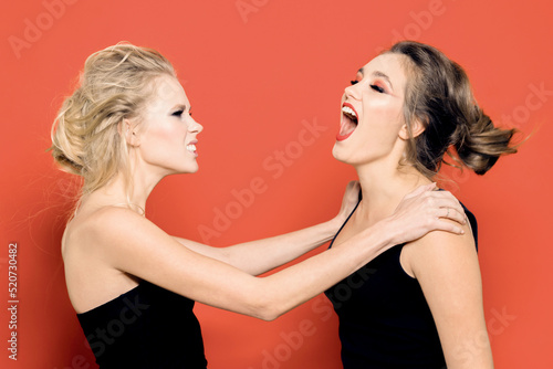 Two girls swear in the studio. One of them is screaming. Negative emotions. photo