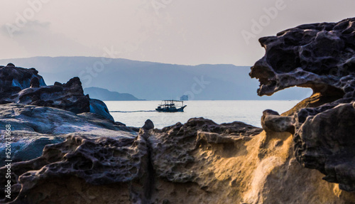 Принти на полотні A fisherman boat floats past Mushroom rocks in Yeh Liu Geopark, Taiwan