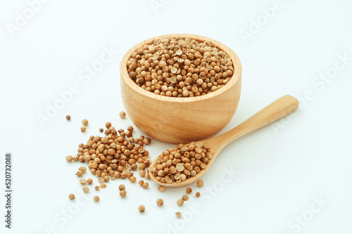 Coriander seed in wooden bowl with spoon isolated on white background , top view , flat lay.