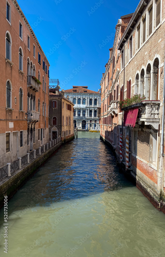 The view of the calm narrow canal, Venice, Italy