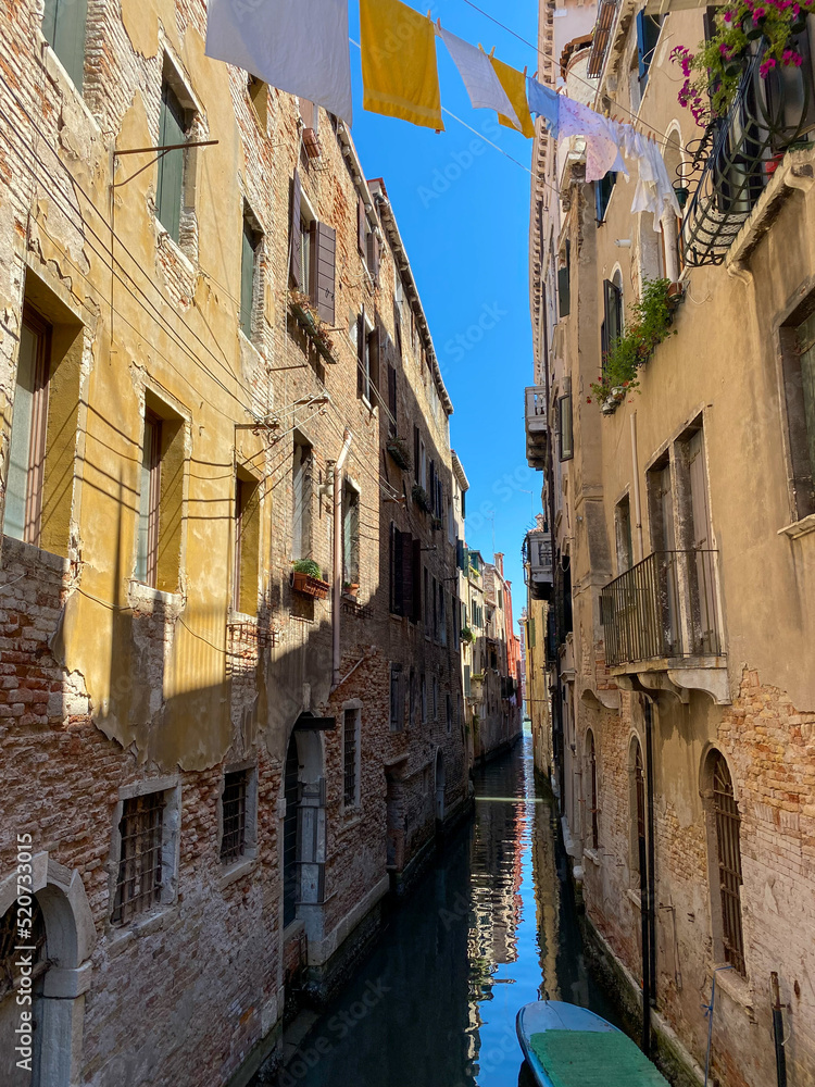 The old narrow street canal in Venice, Italy