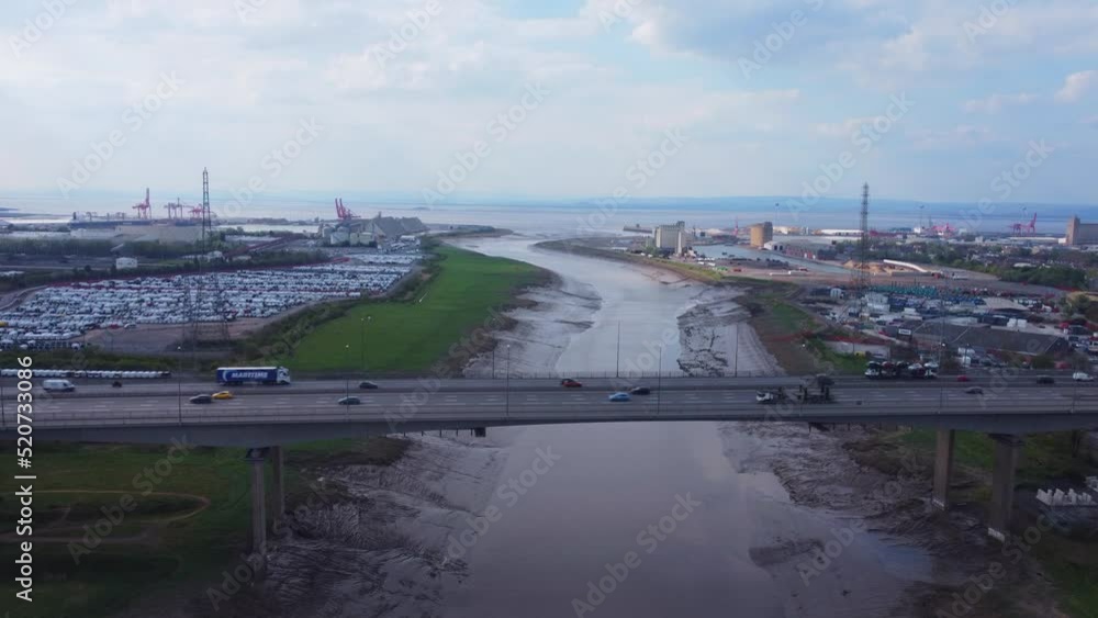 Rising drone shot over River Avon in Bristol looking over busy M5 Motorway bridge with Avonmouth docks and bristol channel in the distance Rising drone shot over River Avon in Bristol looking over busy M5 Motorway bridge with Avonmouth docks and bristol channel in the distance