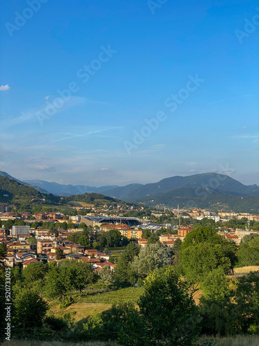 Cityscape with green mountains in the background  Italy
