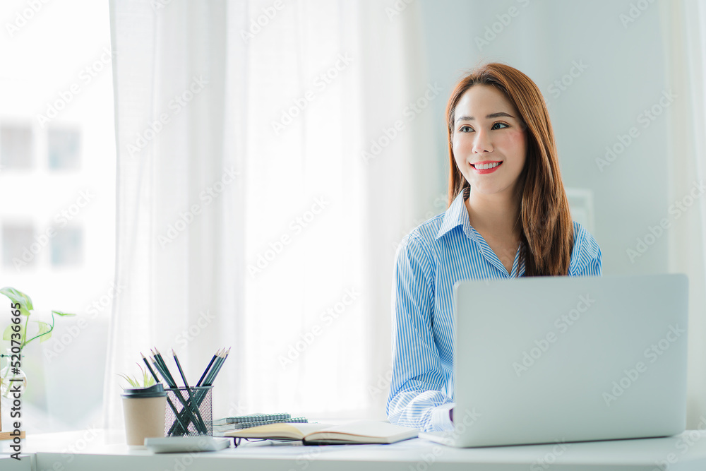 beautiful asian business woman Millennial professional female financial analyst working on financial charts and chart data with laptop in the office. beautiful asian business woman Millennial professional female financial analyst working on financial charts and chart data with laptop in the office.