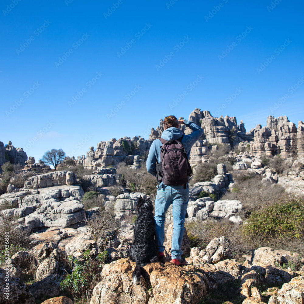 backpack man and dog in Torcal,  Spain