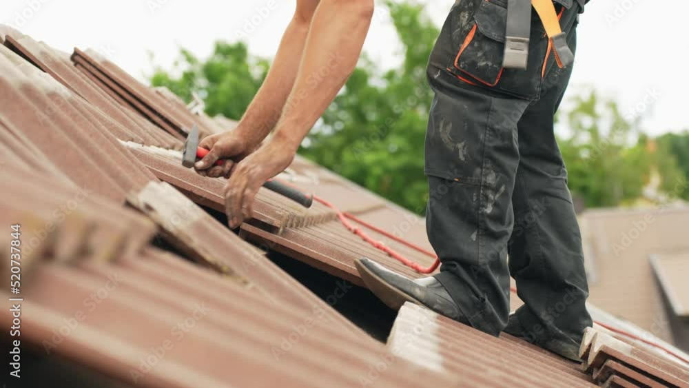 Handyman fixing roof with new tiles, work in hight Handyman fixing roof with new tiles, work in hight