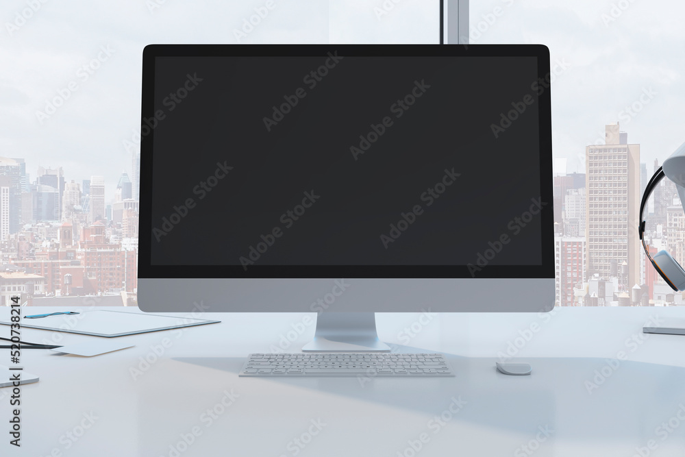 Fototapeta premium Close up of designer desktop with empty black mock up computer monitor laptop and supplies in modern office with window and panoramic city view. 3D Rendering.