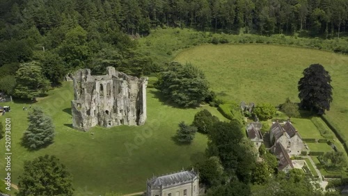 View over Old Wardour Castle in a forest setting with bright green sunny fields. photo