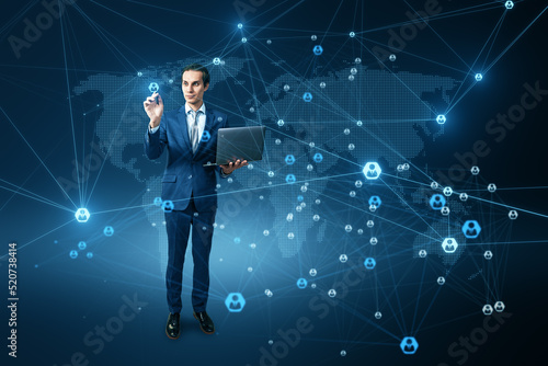 Attractive young european businessman with abstract glowing digital map and connections on blue background. Communication and network concept.