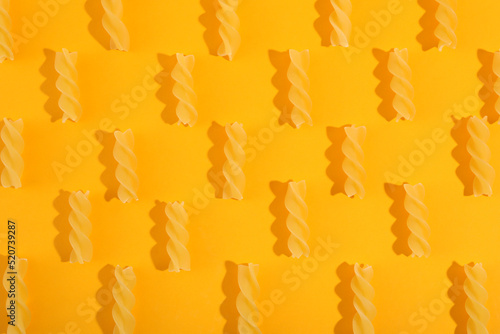 Flat lay with fusilli on orange background