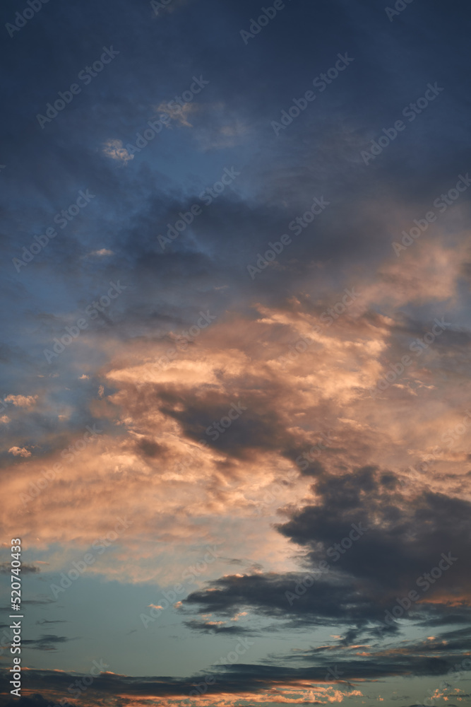 Blue sky with orange and white clouds. Teal and orange dreamy color cloudscape background.