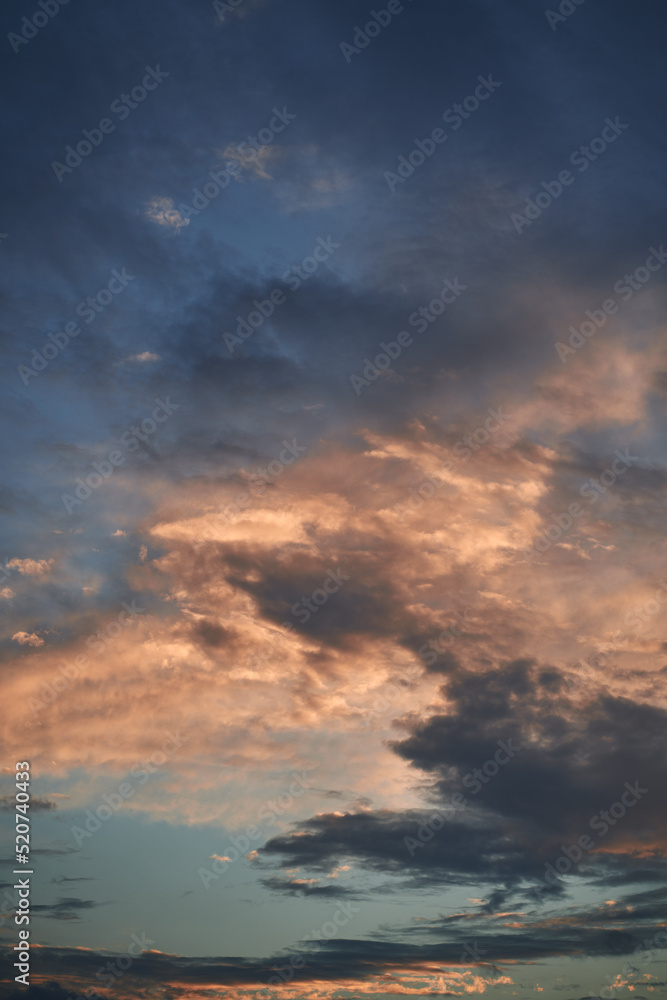 Blue sky with orange and white clouds. Teal and orange dreamy color cloudscape background. Blue sky with orange and white clouds. Teal and orange dreamy color cloudscape background.