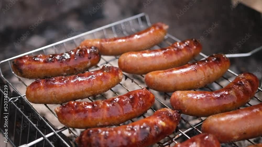 close-up view of tasty sausages grilling on charcoal grill grate close-up view of tasty sausages grilling on charcoal grill grate