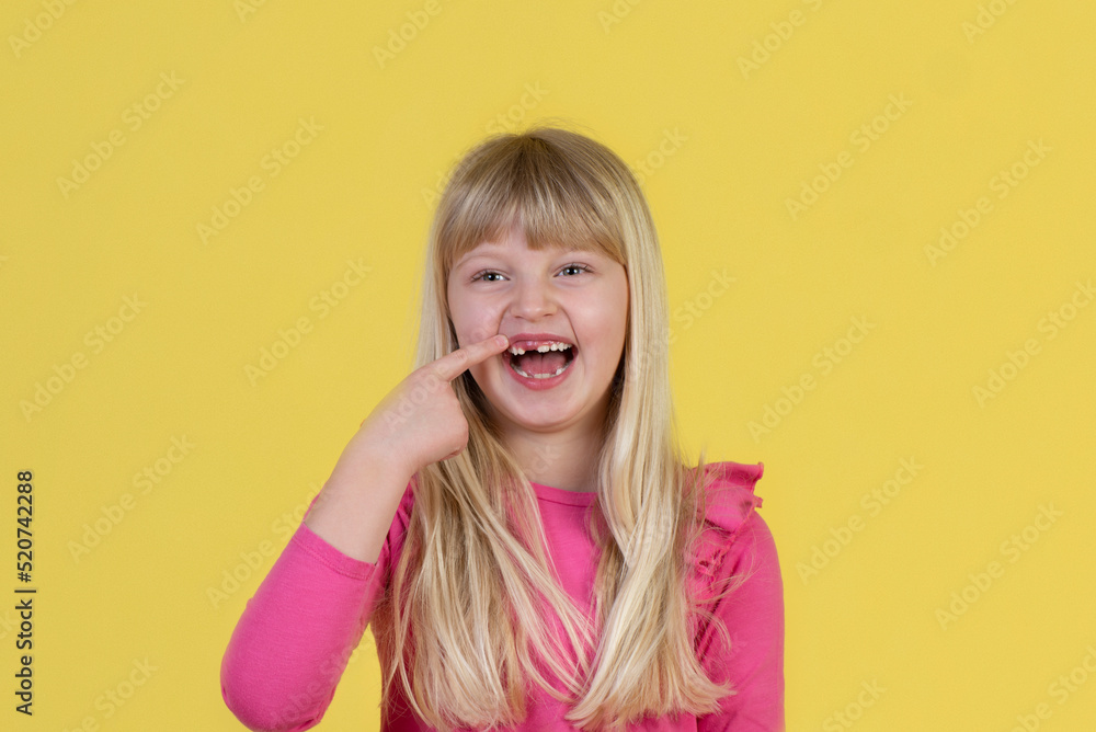 Portrait of little girl smiling and showing her teeth Portrait of little girl smiling and showing her teeth
