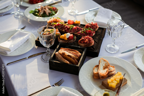 festive table with various dishes on a white tablecloth