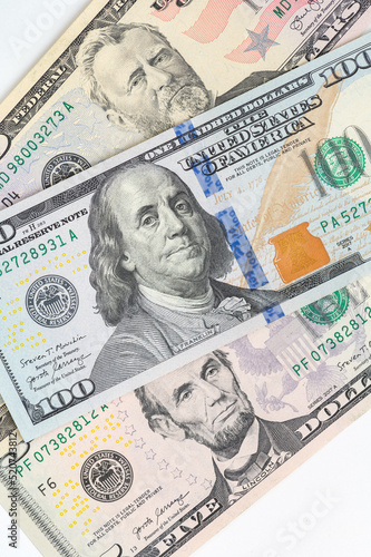 Wallpaper Mural 5, 20, 50, 100 dollars banknotes at different angles. Close up of dollars on white background. Torontodigital.ca