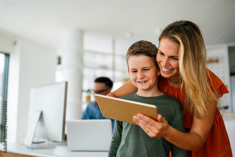 Mother and child using digital tablet for e-learning. Education home digital device kid concept. Mother and child using digital tablet for e-learning. Education home digital device kid concept.
