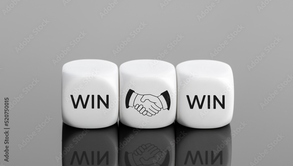 Win Win concept. Business deal. Word and handshake Icon on cube blocks. Copy space Win Win concept. Business deal. Word and handshake Icon on cube blocks. Copy space