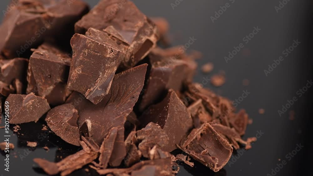 Chocolate, Chunks of sweet dark chocolate rotating on grey background, close-up. Gourmet dessert ingredient. Premium Confectionery, confection concept. Sweet dessert. 4K UHD video Chocolate, Chunks of sweet dark chocolate rotating on grey background, close-up. Gourmet dessert ingredient. Premium Confectionery, confection concept. Sweet dessert. 4K UHD video