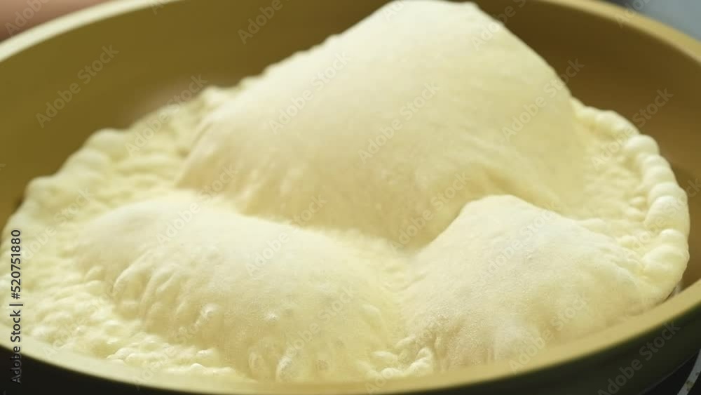 The pita bread begins to bake in the frying pan.
The pita bread begins to bake in the frying pan.