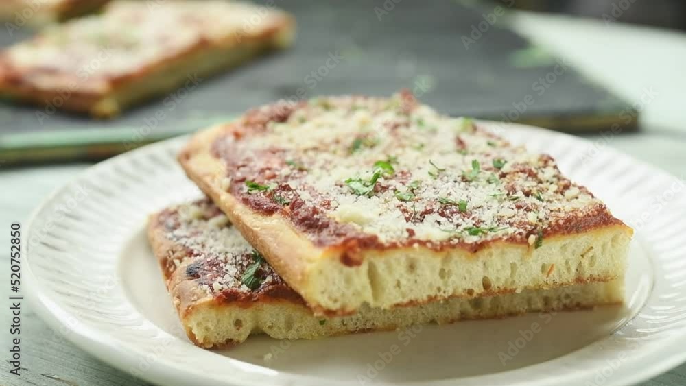 The chef places a piece of philly-style pie on the plate.
The chef places a piece of philly-style pie on the plate.