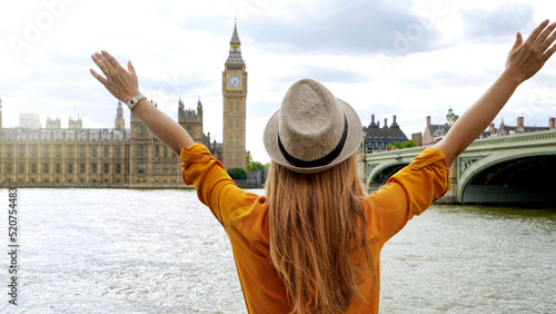 Photography Enthusiastic traveler student girl with raised arms in London enjoying the view