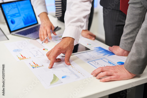 Business people in meeting analyzing graphs
