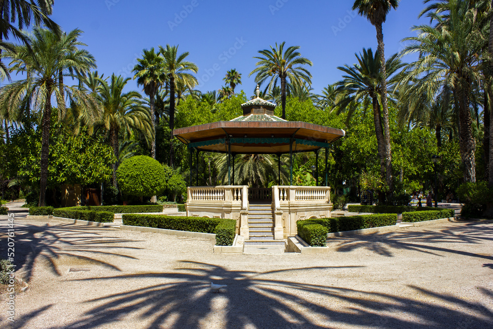 Roundabout, Colomer. Elche, Alicante. Elche municipal park. Landscape with palm trees.