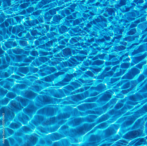 Blue water in swimming pool with sun reflection