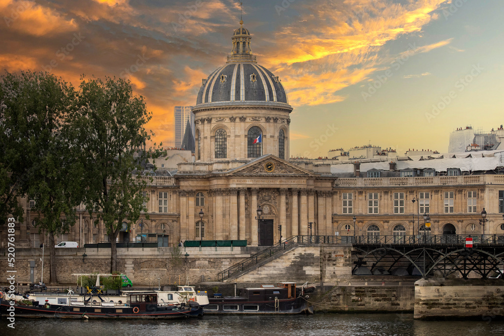 The Institute of France by the Seine River under a beautiful sunset creating a beautiful city in Paris, contributing to the creation of a nice contrast, scenery and background of the Parisian city.