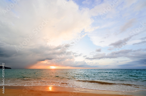 Seascape with sunset on the ocean shore. Beautiful cloudy sky.